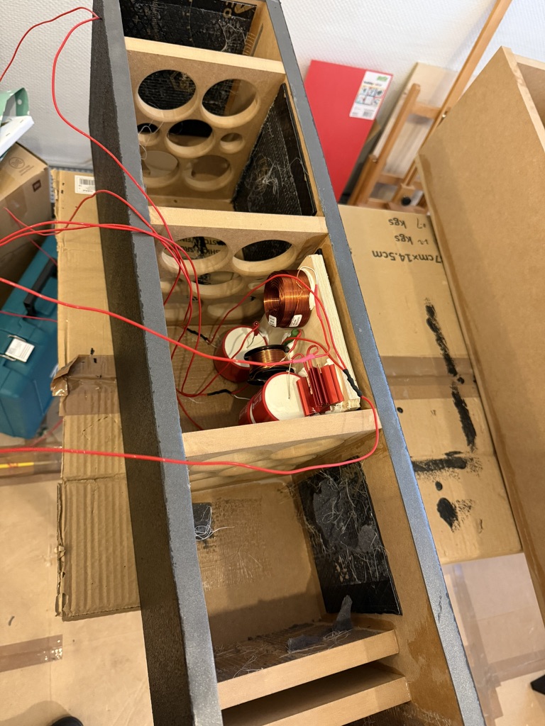 Internal view showing chambers, wiring loom, and the front-firing slot port