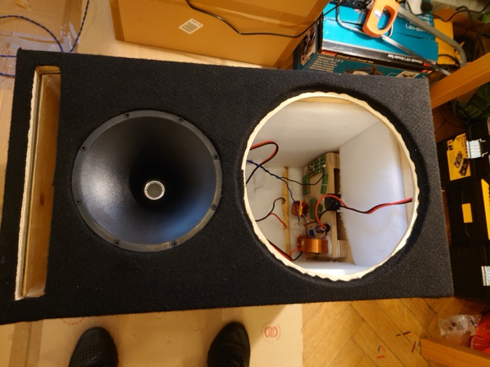 Finished textured cabinet with the horn mounted and the crossover visible through the open woofer cutout