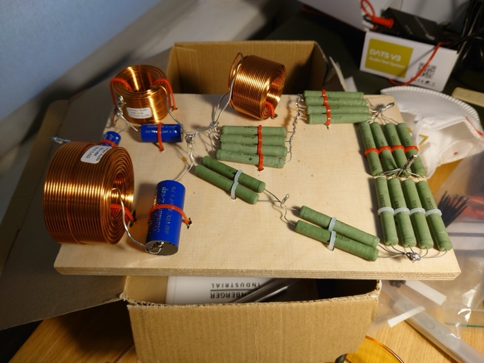 Crossover components laid out on a board — air-core inductors, ClarityCap capacitors, and the parallel wirewound resistor L-pad array